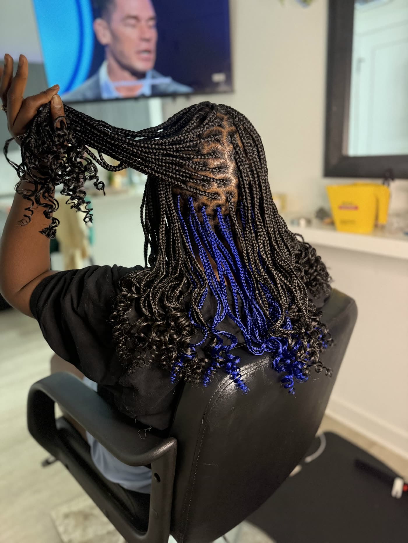 Knotless braids with electric blue accent pieces worked through