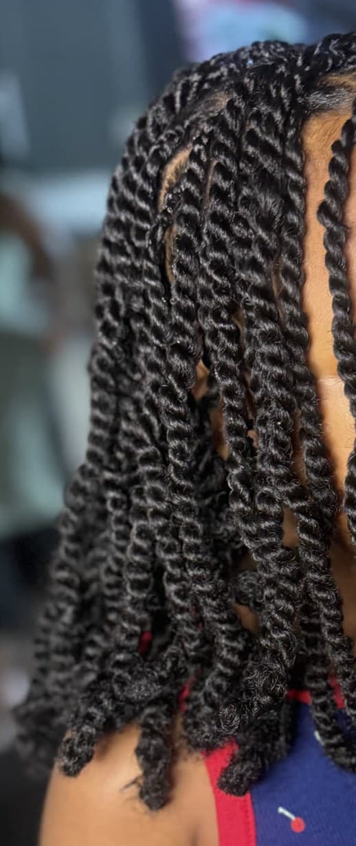 Close detail of a child's two-strand twists with curled ends