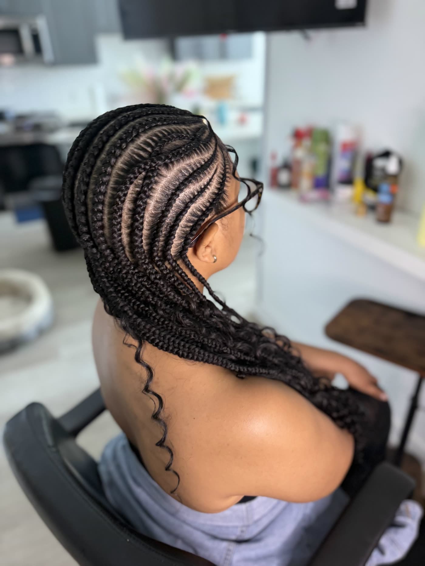 Side view of clean stitch cornrows feeding into long braids